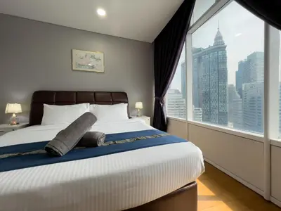 a bedroom with a large bed with a large window at Vortex Suites KLCC By GuestHouse in Kuala Lumpur
