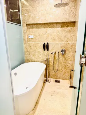 a bathroom with a sink and a bath tub at Dorsett Serviced Suites Kuala Lumpur By NP in Kuala Lumpur