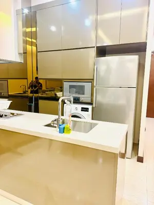 a kitchen with a sink and a refrigerator at Dorsett Serviced Suites Kuala Lumpur By NP in Kuala Lumpur