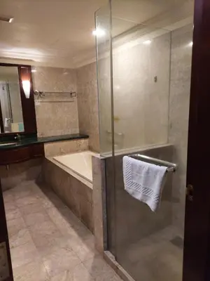 a bathroom with a shower and a tub and a sink at Glacier suite at times square kl in Kuala Lumpur