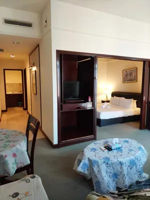 a hotel room with two tables and a bed at Glacier suite at times square kl in Kuala Lumpur