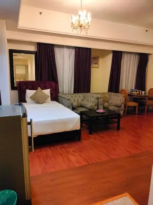 a hotel room with a bed and a couch at KL Heart Suite at berjaya Times Square in Kuala Lumpur