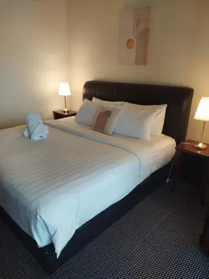 a bedroom with a large bed with white sheets and pillows at KL Heart Suite at berjaya Times Square in Kuala Lumpur