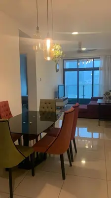 a dining table and chairs in a living room at Cozy Stay at Legasi 5 min Walking distance to KLCC 2 in Kuala Lumpur