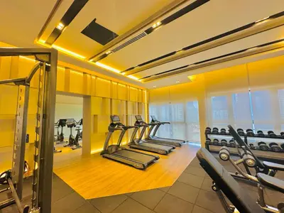 a gym with a row of treadmills and machines at City view Service Residence At Times Square kL in Kuala Lumpur