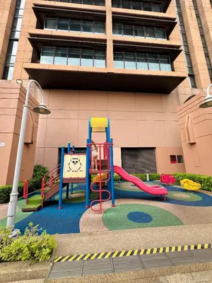 a playground with a slide in front of a building at City view Service Residence At Times Square kL in Kuala Lumpur