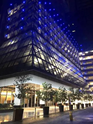 a building with trees in front of it at night at The Platinum KLCC By Elegant Suites in Kuala Lumpur