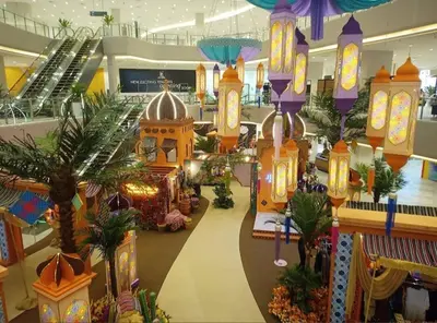 a shopping mall with palm trees and lights at Datum Jelatek SKY Ring in Kuala Lumpur