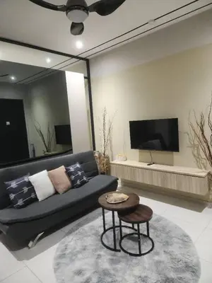a living room with a couch and a table at Datum Jelatek SKY Ring in Kuala Lumpur