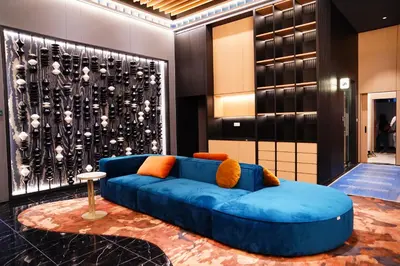 a blue couch in a room with a wall at Majestic Residence Kuala Lumpur City Centre in Kuala Lumpur