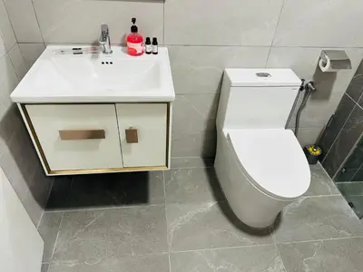 a bathroom with a white toilet and a sink at Majestic Residence Kuala Lumpur City Centre in Kuala Lumpur