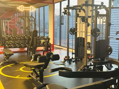 a gym with a lot of treadmills and weights at Majestic Residence Kuala Lumpur City Centre in Kuala Lumpur