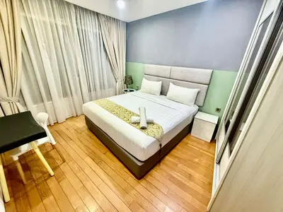 a bedroom with a bed and a desk in it at Vortex Suites Klcc By Bukit Bintang in Kuala Lumpur