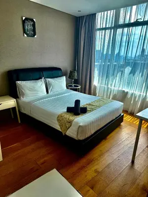 a bedroom with a bed and a large window at Vortex Suites Klcc By Bukit Bintang in Kuala Lumpur