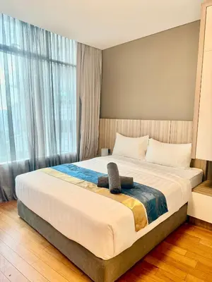 a bedroom with a large bed with a large window at Vortex Suites Klcc By Bukit Bintang in Kuala Lumpur