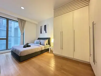 a bedroom with a bed and a large window at Bintang Fairlane Residence, 1 Min to Pavilion KL, Spacious Fam Suite 2B2R in Kuala Lumpur