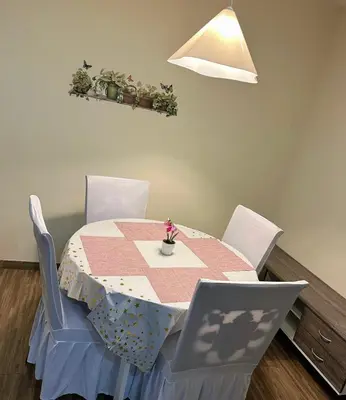 a dining room table with a pink and white table cloth at Setapak Central Mall 2 Bed Zetapark Home Sweet Home in Kuala Lumpur