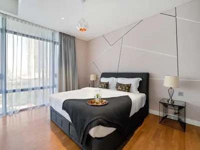 a bedroom with a large bed with a large window at Leo Guesthouse at Anggun Residence Suite in Kuala Lumpur