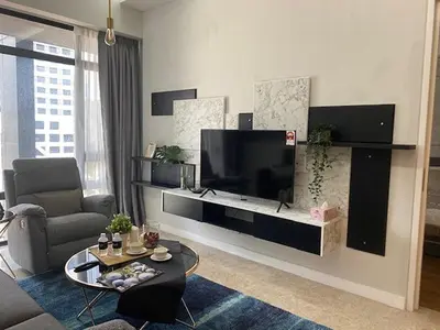 a living room with a large flat screen tv at Leo Guesthouse at Anggun Residence Suite in Kuala Lumpur