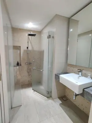 a bathroom with a glass shower and a sink at Leo Guesthouse at Anggun Residence Suite in Kuala Lumpur