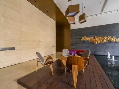 a living room with a table and chairs and a pool at Leo Guesthouse at Anggun Residence Suite in Kuala Lumpur
