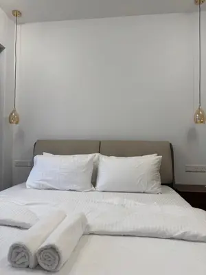 a bed with two towels on top of it at KHR Service Suites Agile Bukit Bintang in Kuala Lumpur