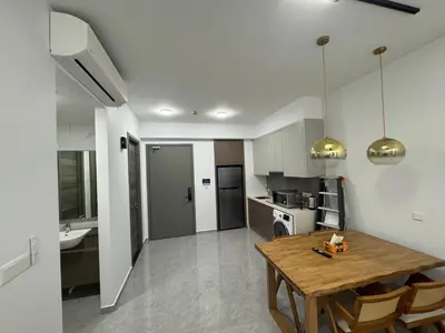 a kitchen and dining room with a wooden table at KHR Service Suites Agile Bukit Bintang in Kuala Lumpur