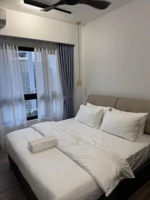 a bedroom with a large white bed with a window at KHR Service Suites Agile Bukit Bintang in Kuala Lumpur