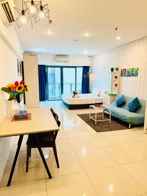 a large living room with a couch and a table at The Mercu Summer Suites By Skyline in Kuala Lumpur