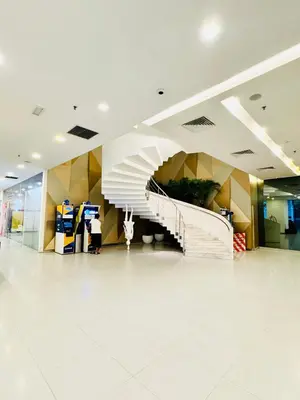 a staircase in a mall with a white tile floor at The Mercu Summer Suites By Skyline in Kuala Lumpur