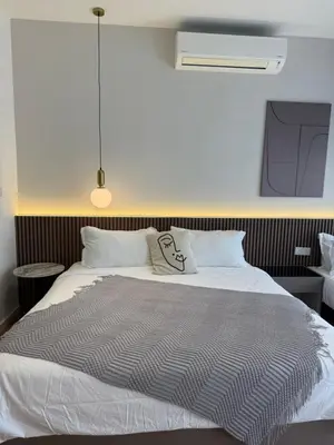 a bedroom with a bed with a pillow on it at Quill Residence - Sky Glass Condo by Azmila in Kuala Lumpur
