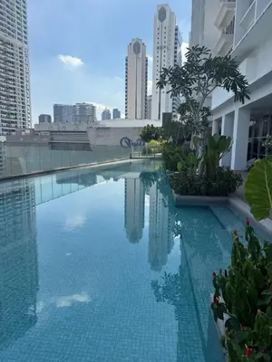 a swimming pool in the middle of a city with tall buildings at Quill Residence - Sky Glass Condo by Azmila in Kuala Lumpur