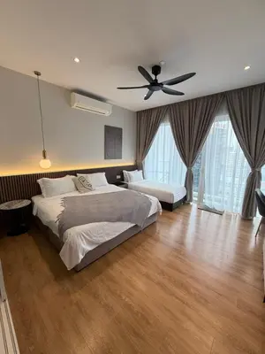 a bedroom with two beds and a ceiling fan at Quill Residence - Sky Glass Condo by Azmila in Kuala Lumpur
