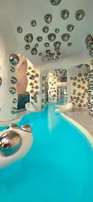 a room with a pool of blue water and a ceiling at KLCC City View Retreat Cozy Spacious Apartment 2BR 2BTH in Kuala Lumpur