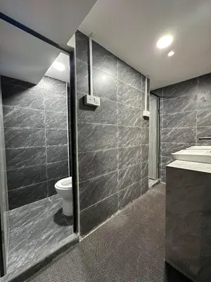 a bathroom with a toilet and a sink at SS Grey House Bukit Bintang KL in Kuala Lumpur