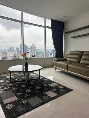 a living room with a couch and a table at Newly Renovated 3 Bedroom Vortex Suites KLCC by Tharwa in Kuala Lumpur