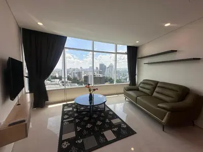 a living room with a couch and a large window at Newly Renovated 3 Bedroom Vortex Suites KLCC by Tharwa in Kuala Lumpur