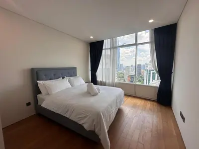 a bedroom with a bed and a large window at Newly Renovated 3 Bedroom Vortex Suites KLCC by Tharwa in Kuala Lumpur