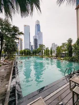 a swimming pool with a city skyline in the background at La Gente x Agile Bukit Bintang TRX Pavilion KL in Kuala Lumpur