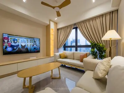 a living room with a couch and a tv at La Gente x Agile Bukit Bintang TRX Pavilion KL in Kuala Lumpur
