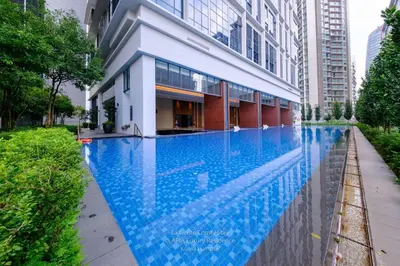 a swimming pool in front of a building at Luxe Spacious 2BR Condo KLCC 600mbps Full Furnish in Kuala Lumpur
