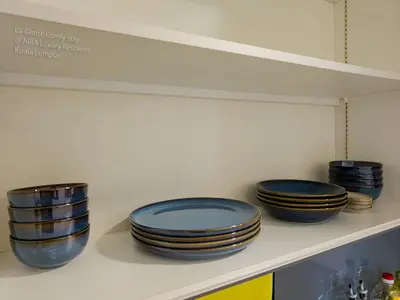 four blue plates are sitting on a shelf at Luxe Spacious 2BR Condo KLCC 600mbps Full Furnish in Kuala Lumpur