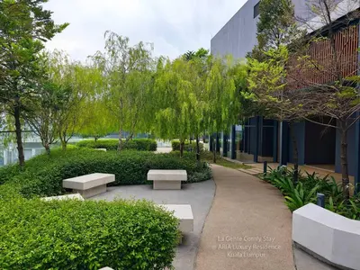 a park with benches and trees next to a building at 2R2B KLCC ARIA Hi Luxury Amazing Facilities ZEN in Kuala Lumpur