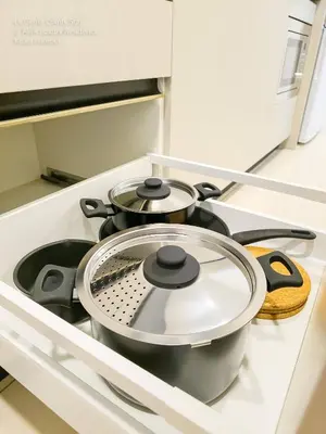 two pots and pans sitting on a stove in a kitchen at 2R2B KLCC ARIA Hi Luxury Amazing Facilities ZEN in Kuala Lumpur