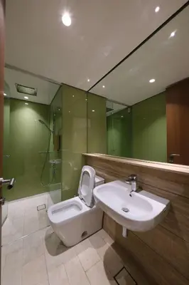 a bathroom with a toilet and a sink and a shower at 3R2B SkySuites Next to KLCC Twin Tower High Floor in Kuala Lumpur