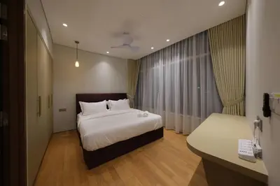 a hotel room with a bed and a desk at 3R2B SkySuites Next to KLCC Twin Tower High Floor in Kuala Lumpur