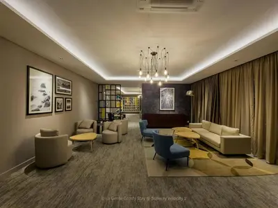 a living room with couches and a table and chairs at 2R2B Velocity TWO KLCC TRX Sunway Medical LaGente in Kuala Lumpur