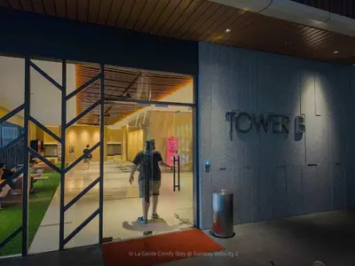 a man standing in front of a glass door at 3BR Sunway Velocity 2 TRX KLCC in Kuala Lumpur