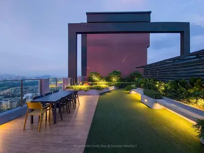 a patio with a table and chairs on a building at 3BR Sunway Velocity 2 TRX KLCC in Kuala Lumpur