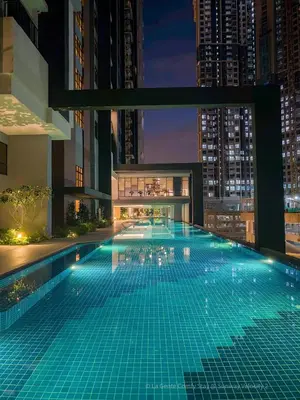 a swimming pool in the middle of a city at night at 3BR Sunway Velocity 2 TRX KLCC in Kuala Lumpur